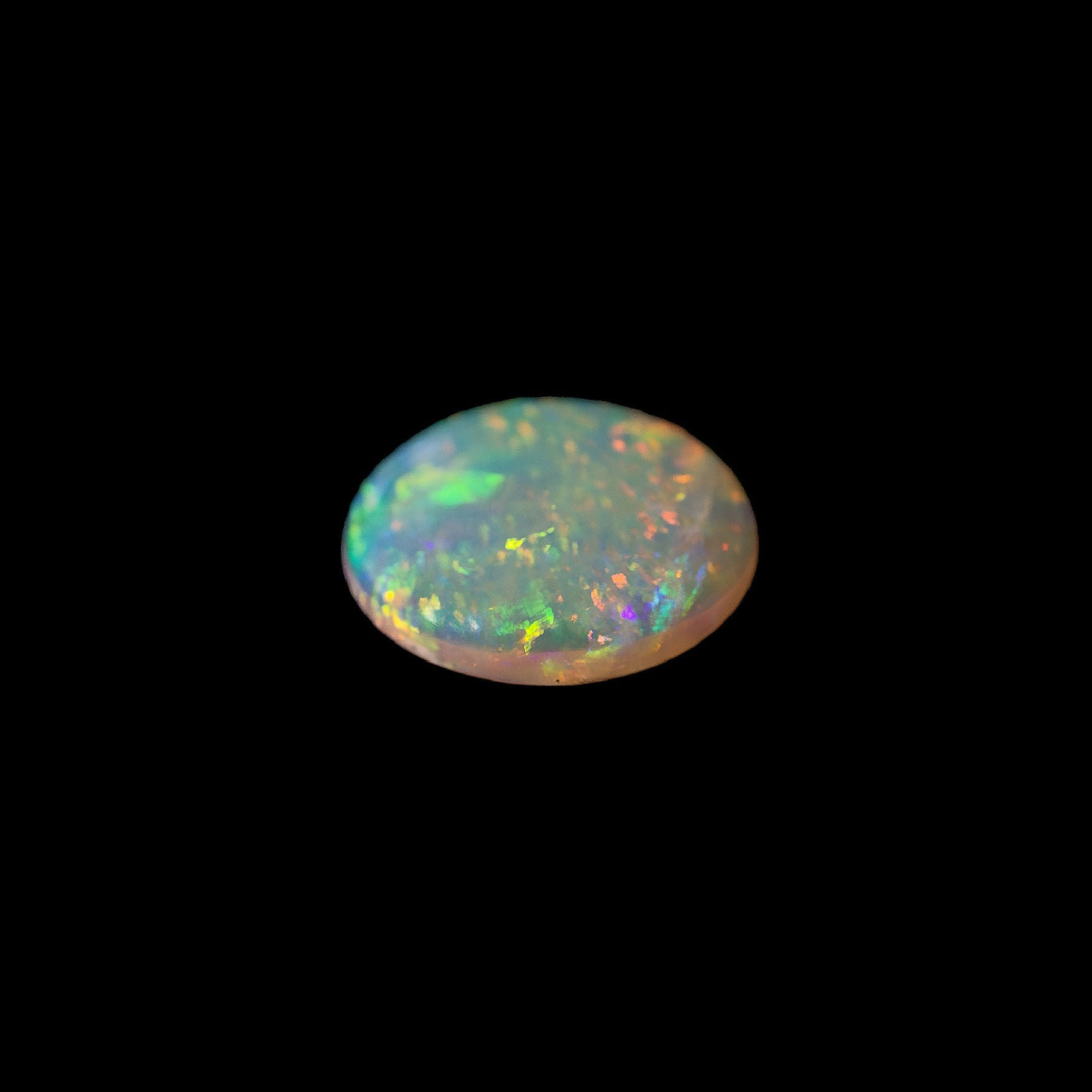 Opal stone with multicolor play on a black background
