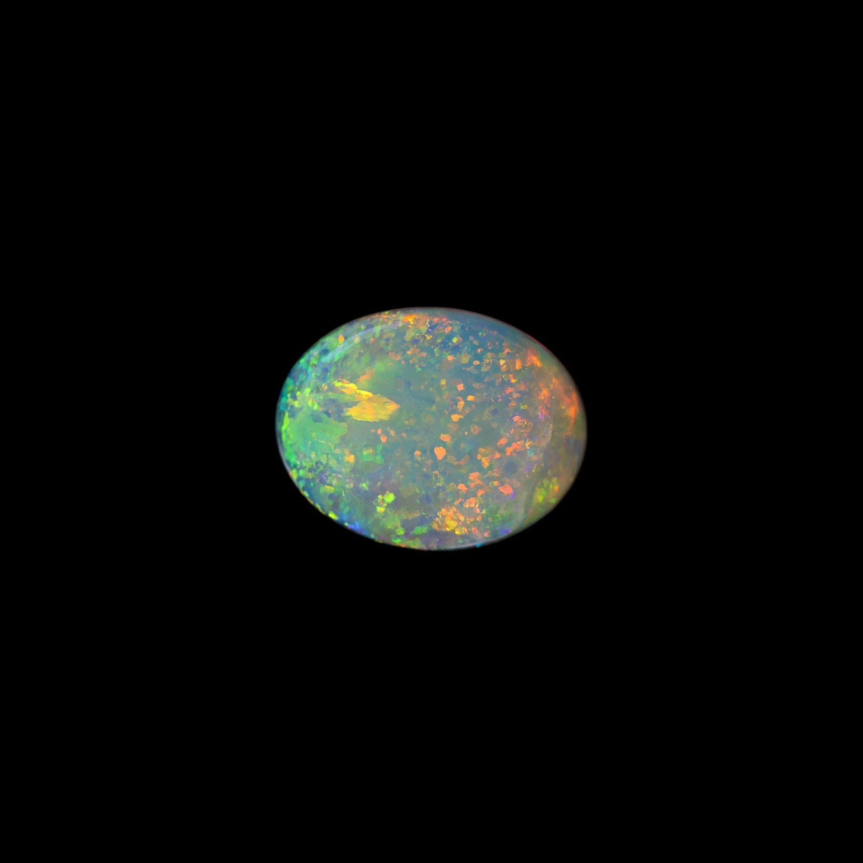 Multicolored opal stone on a black background