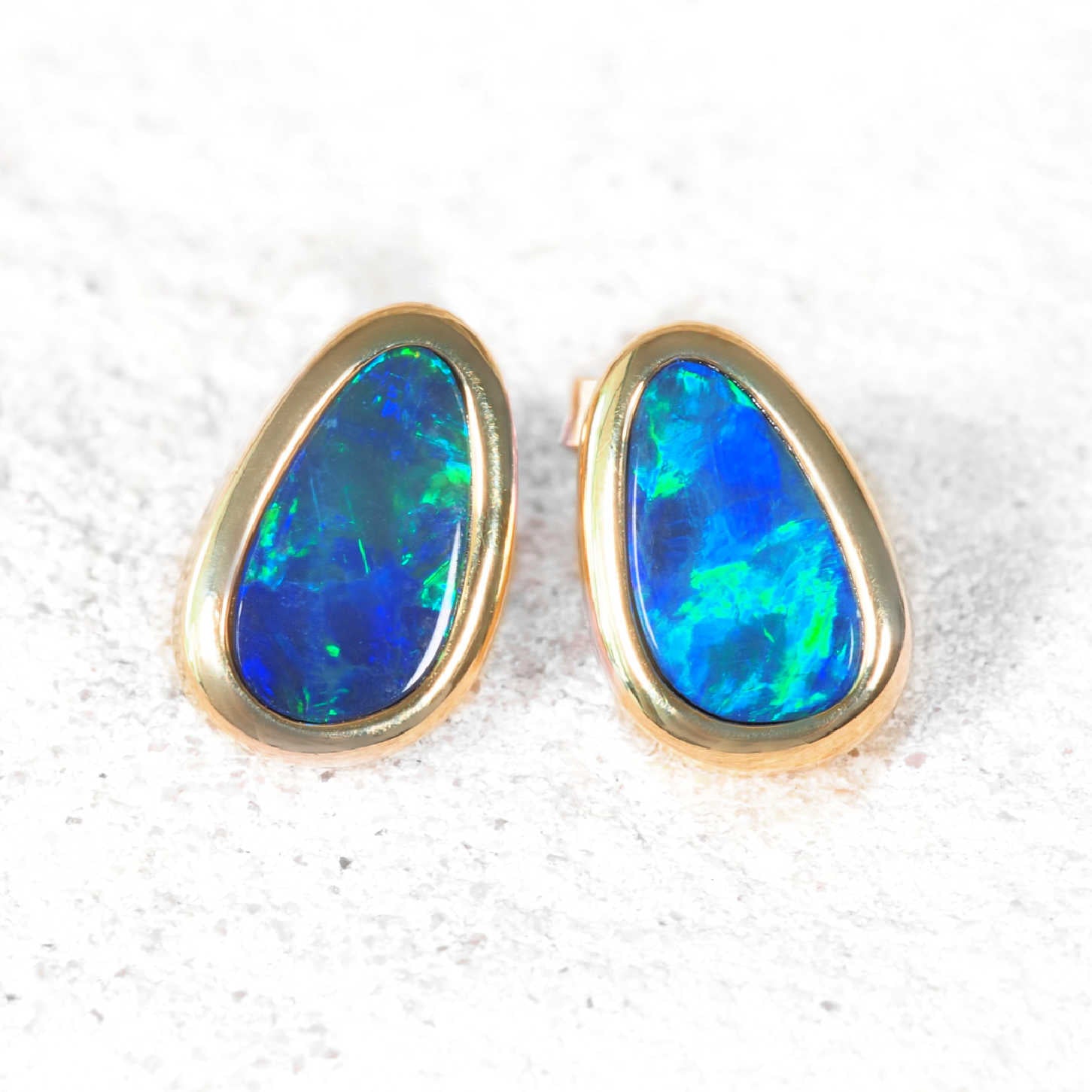Pear-shaped blue-green opal earrings in 14ct yellow gold