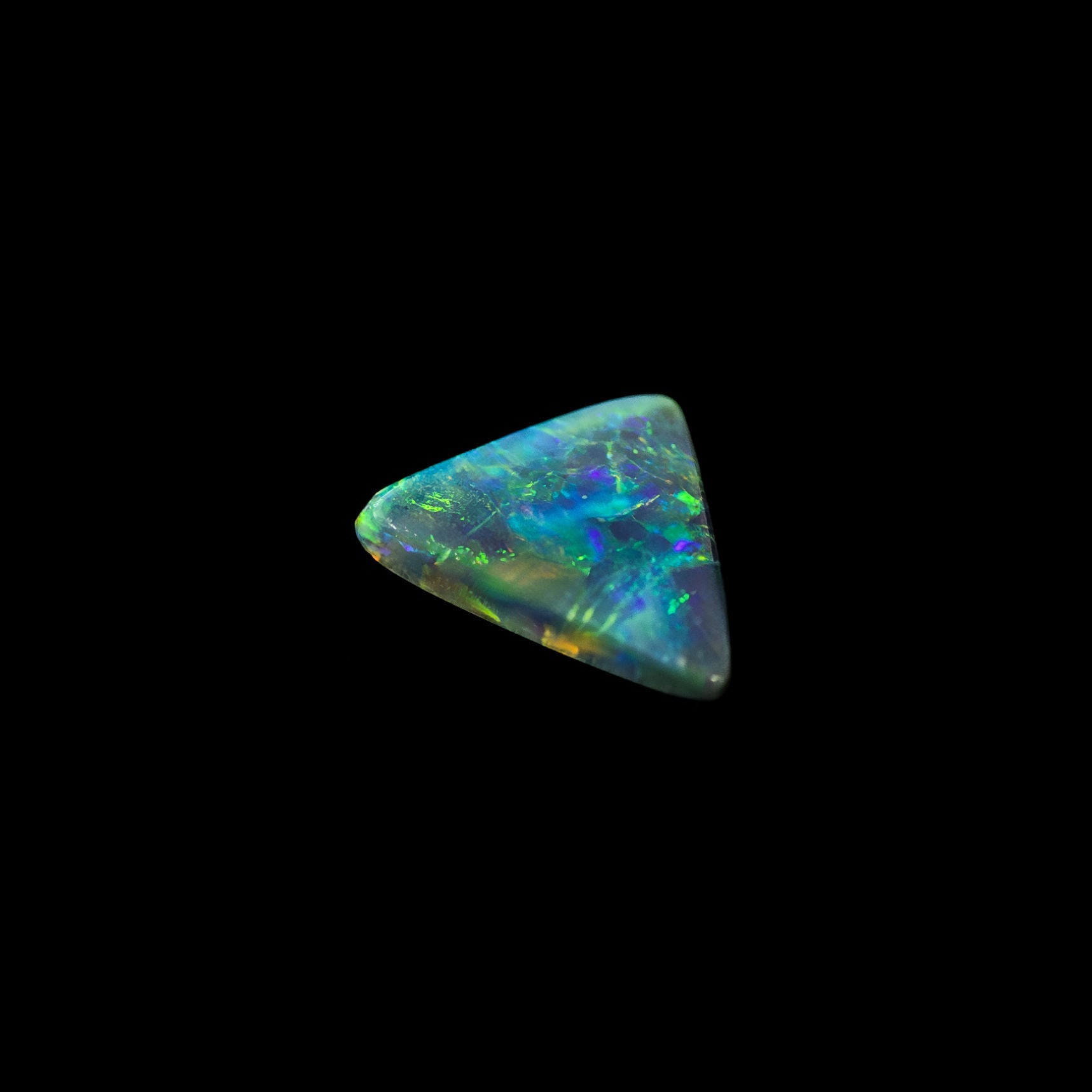 Australian black opal stone on a black background