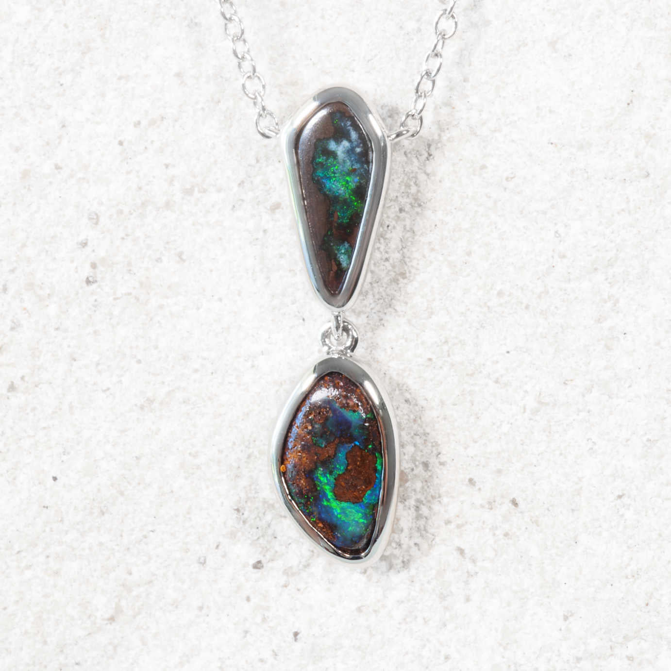 Necklace with two opal stones on a white background