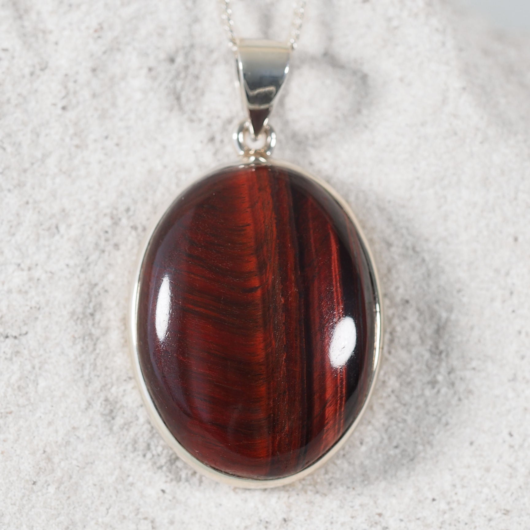 Round Red Tiger Eye cabochon pendant set in sterling silver
