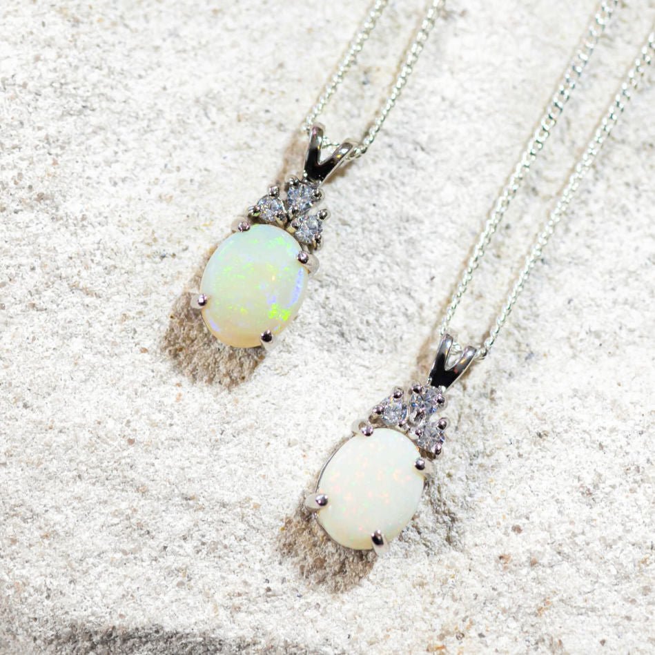 opal pendants set in silver with three diamantes each