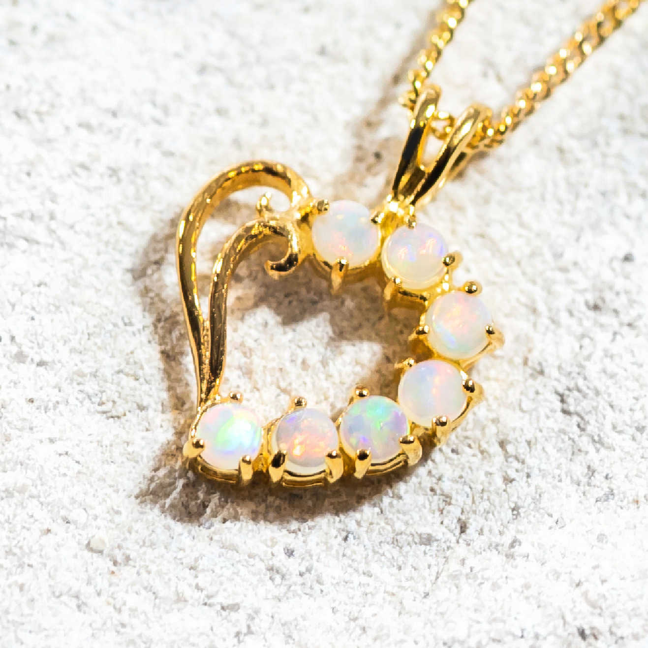 seven opals set into a heart-shaped necklace
