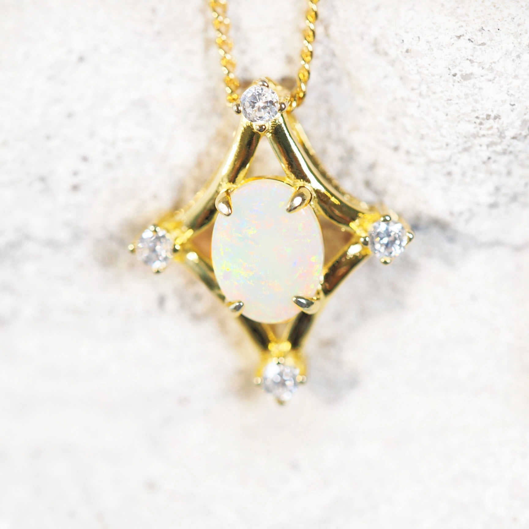 white opal pendant set on gold plated silver