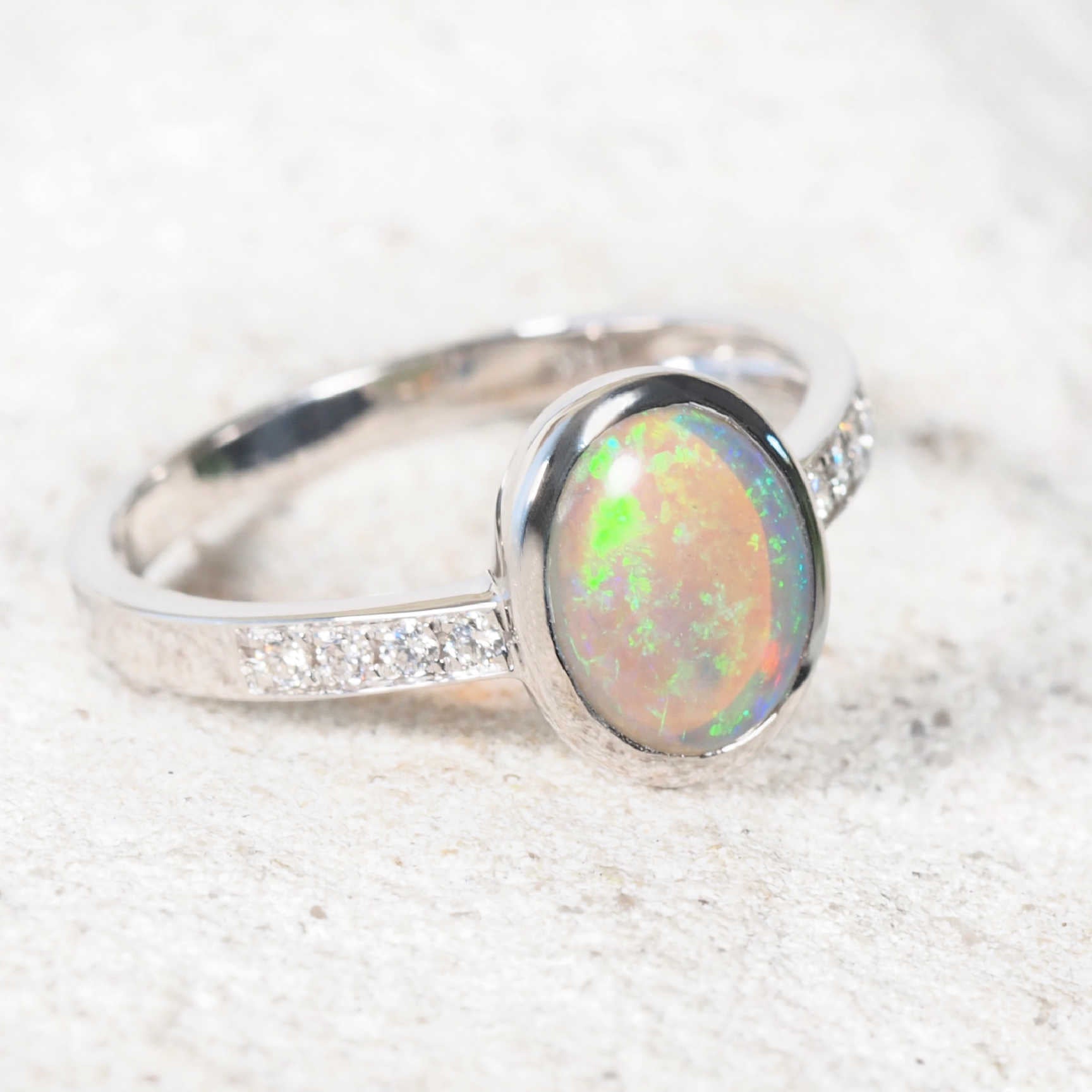 Elegant green opal and diamond ring in polished white gold setting