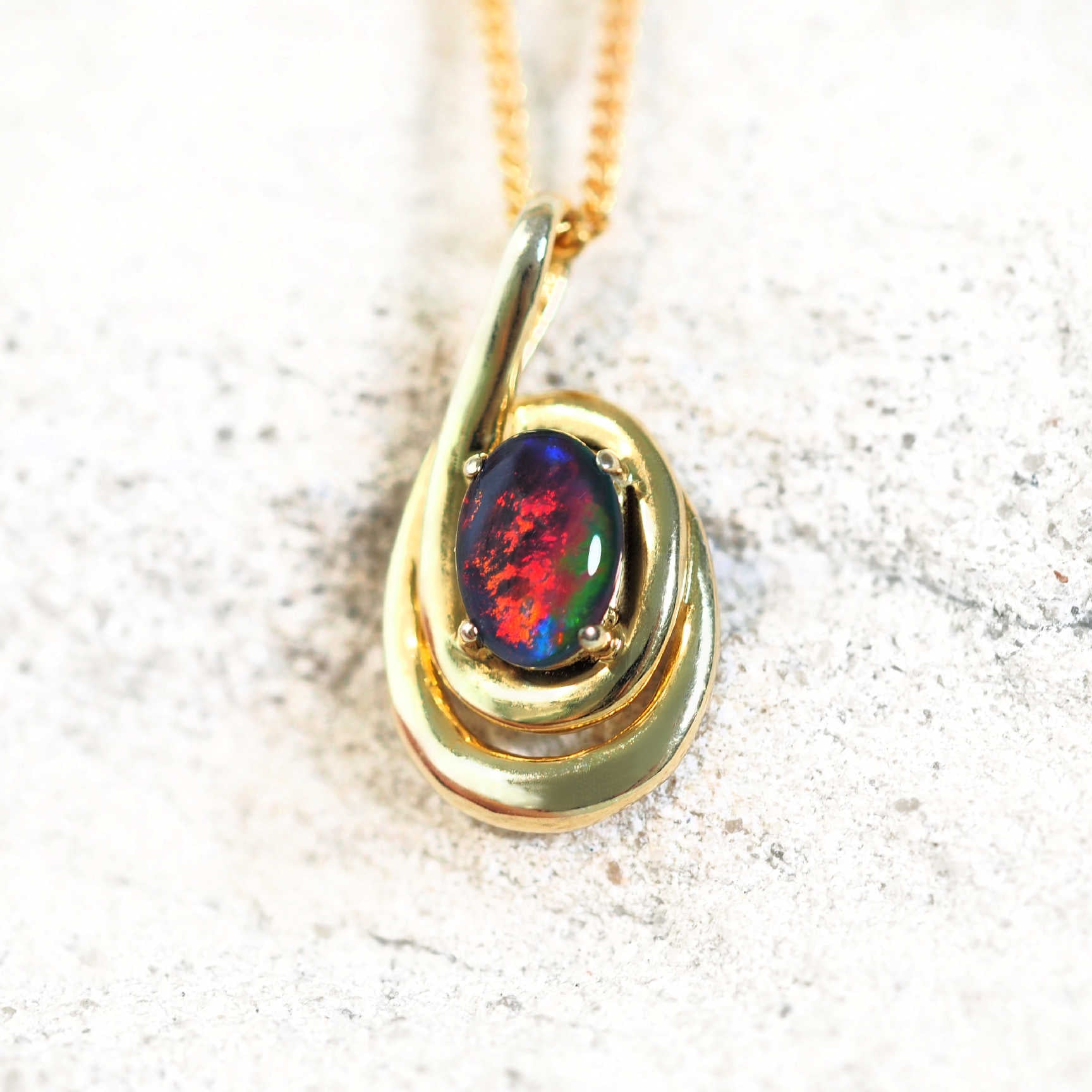 Vianna gold-plated silver opal pendant with colourful oval triplet opal in a double swirl design