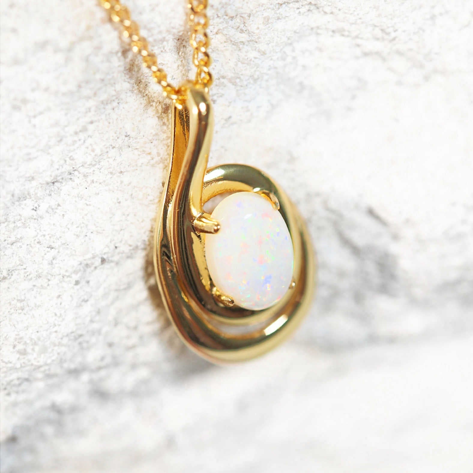 opal pendant with a swirl design