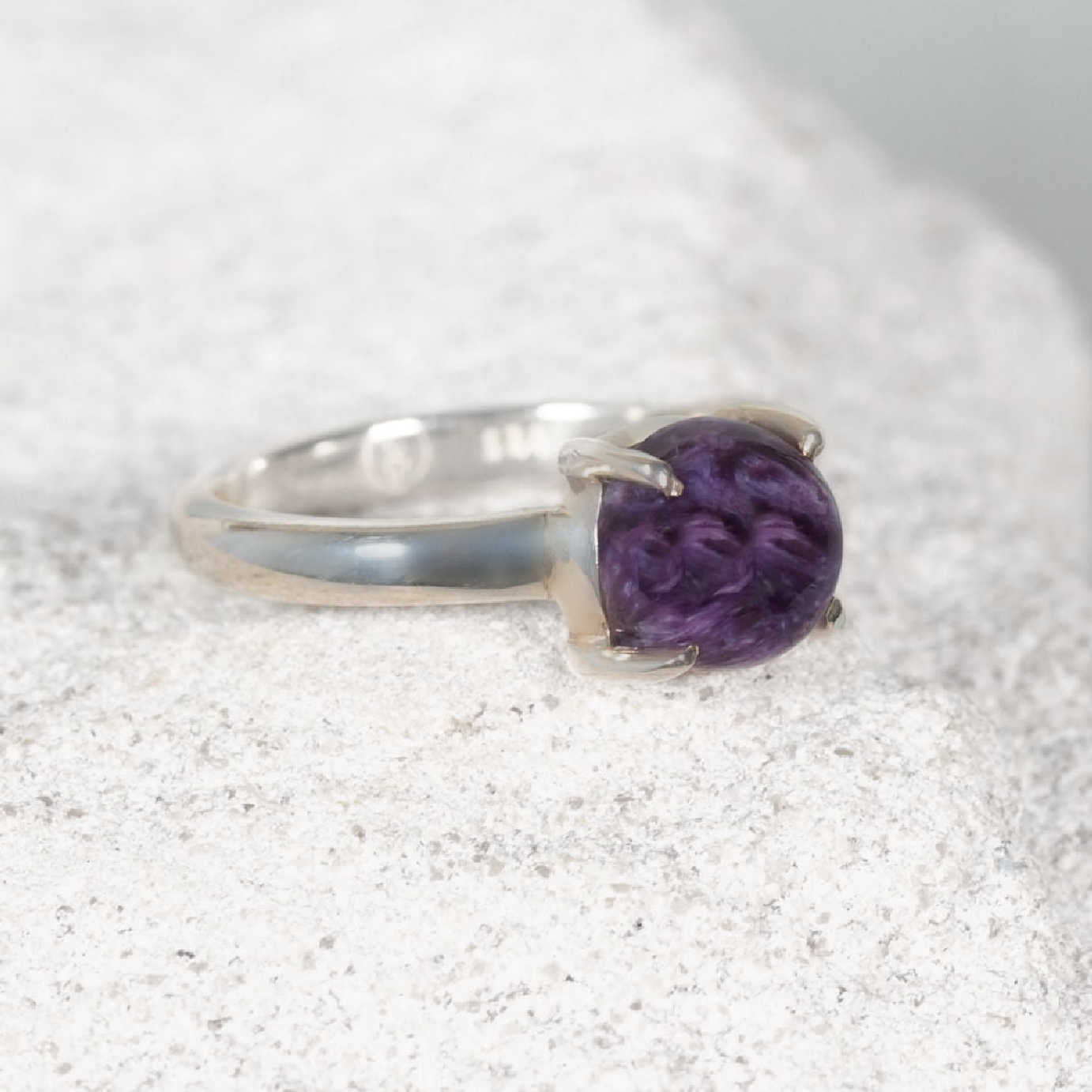 Petite round Charoite ring in polished silver with claw and bezel setting, showing deep purple and lavender tones