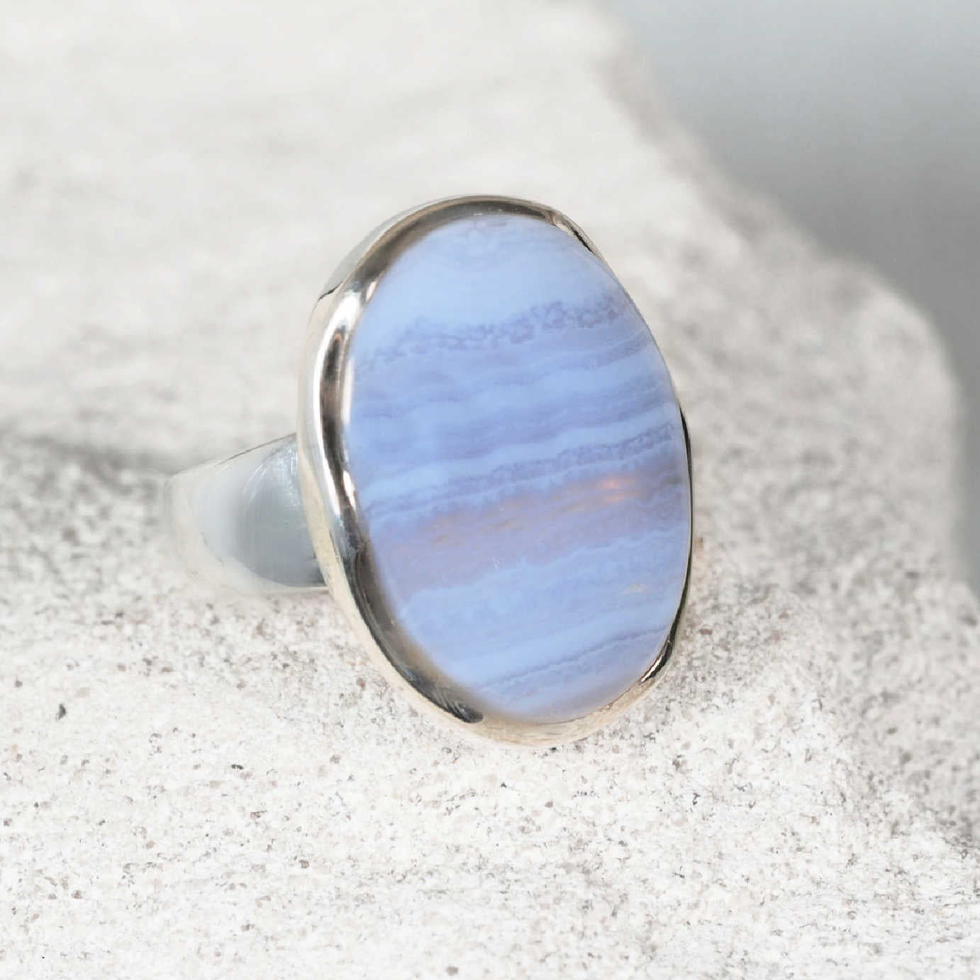 The ‘Vivianne’ silver ring with an oval Blue Lace Agate cabochon showing gentle blue  banded patterns