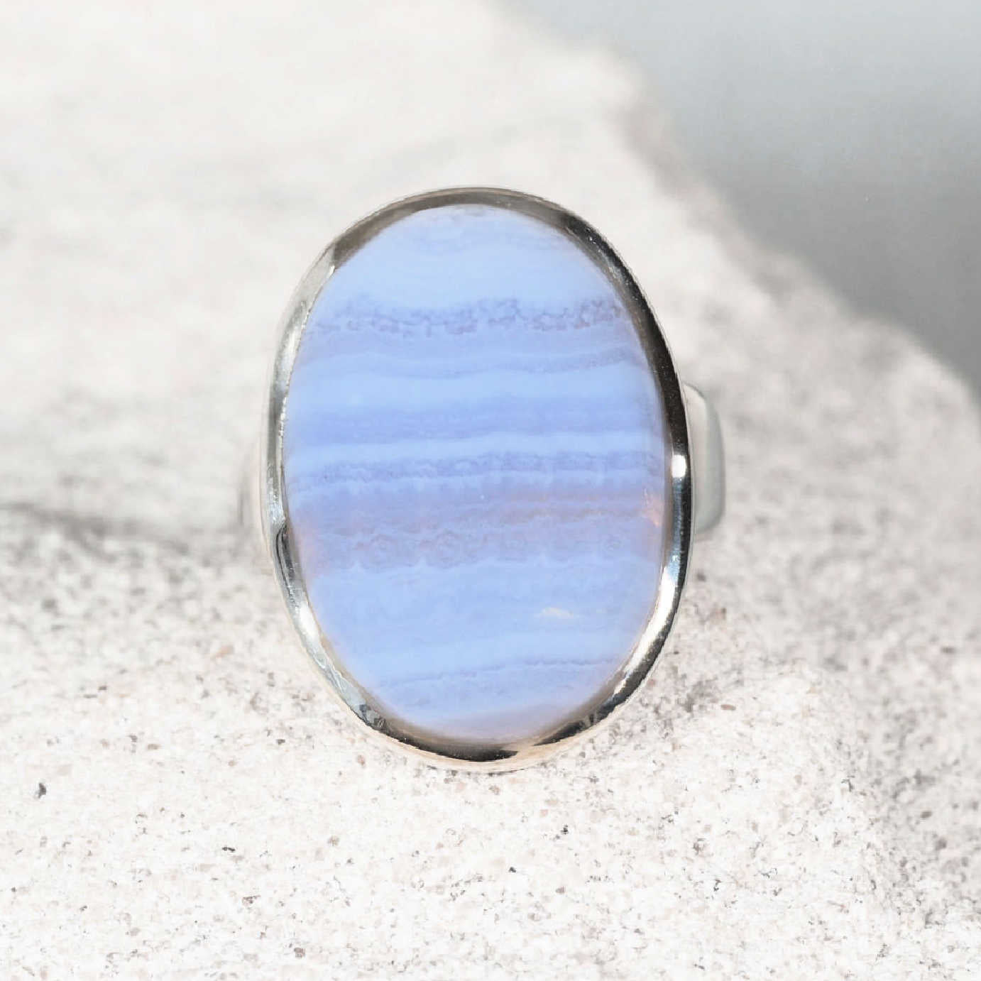 Elegant silver ring, ‘Vivianne,’ showcasing a polished oval Blue Lace Agate gemstone with natural flowing stripes