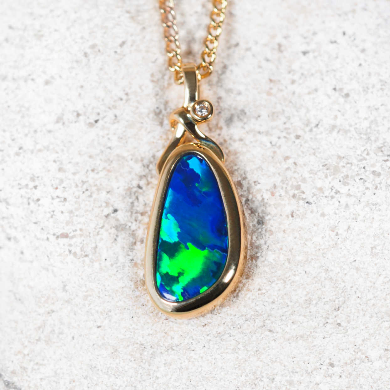 Opal pendant necklace on a textured white background
