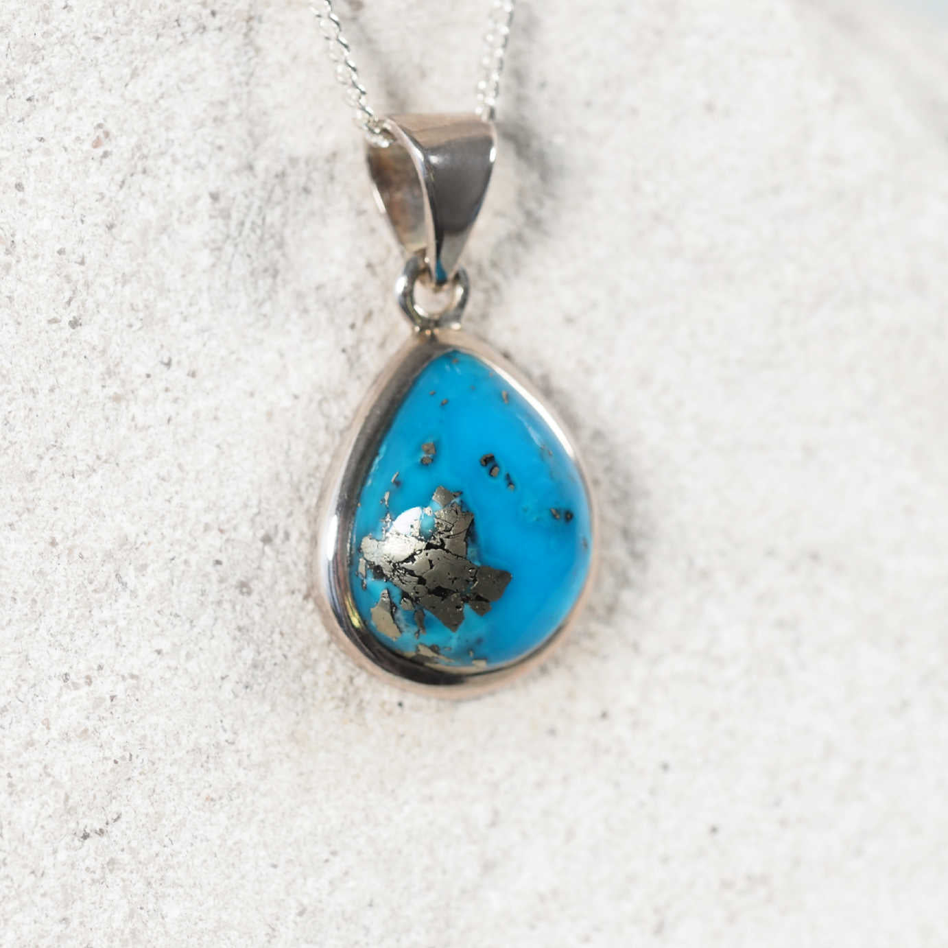 Persian turquoise displaying small speckles of pyrite and blue hues
