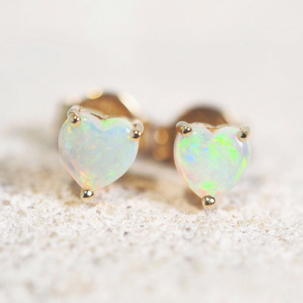 heart shaped crystal opal gold earrings with a green tone