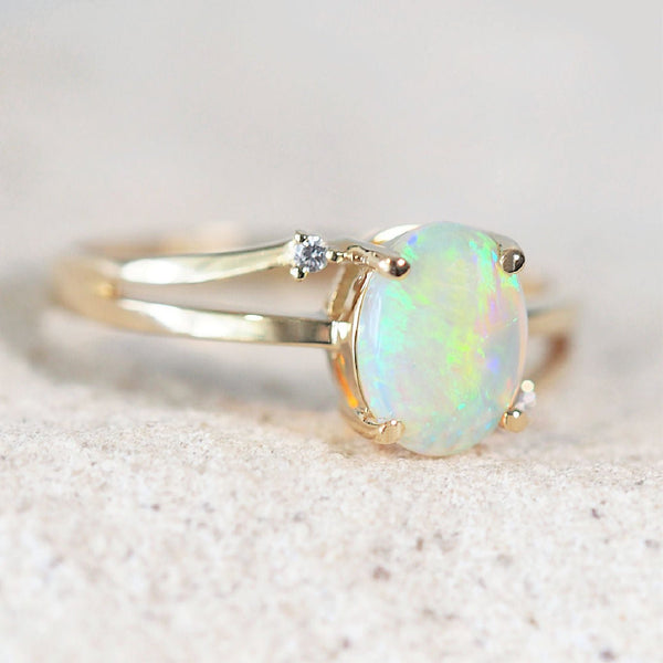 crystal opal gold ring set with an oval green Australian solid opal and two diamonds
