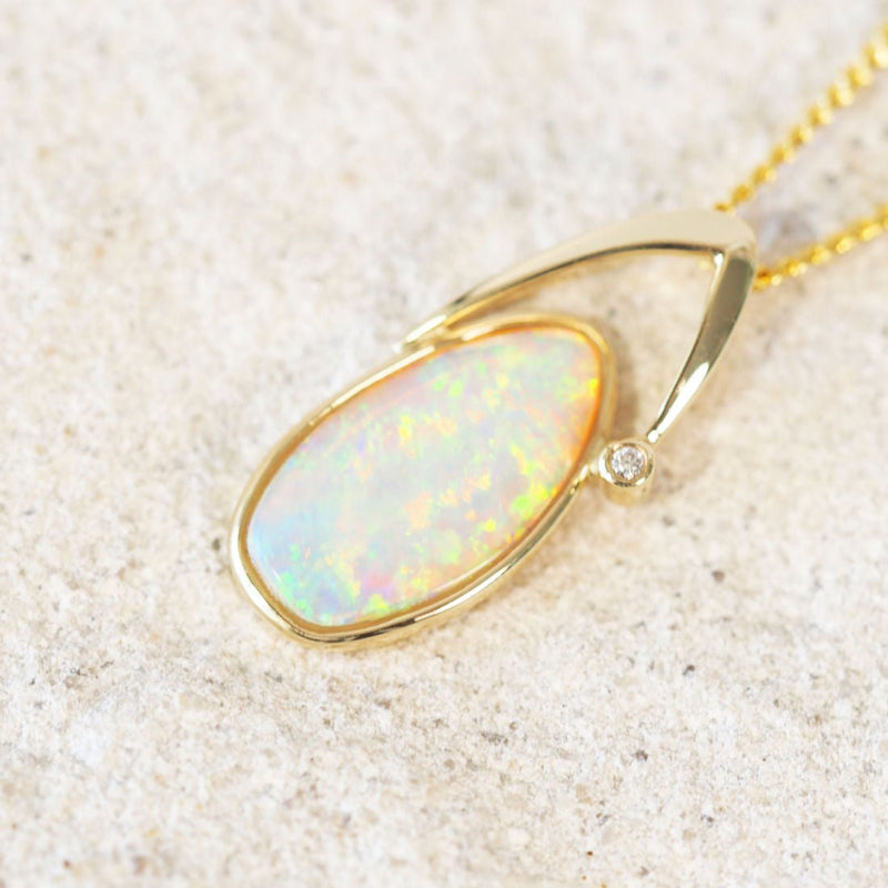 Colourful crystal opal gold pendant with a sparkling diamond