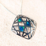 three geometric blue and green doublet opals in a silver pendant