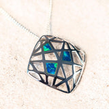 three geometric blue and green doublet opals in a silver pendant