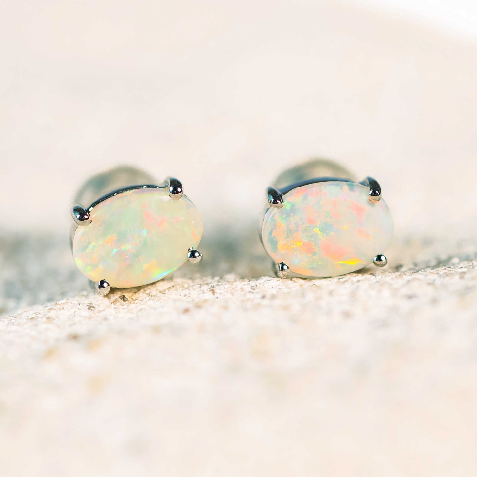 white gold earrings set with australian opals