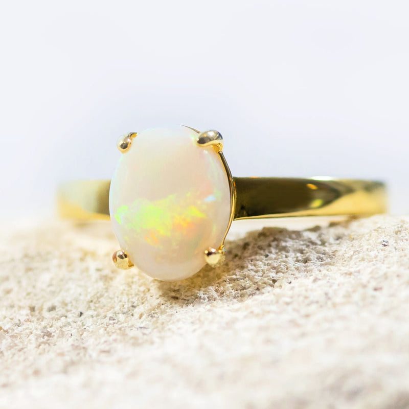 white opal gold plated silver ring set with a multi-colour solid opal
