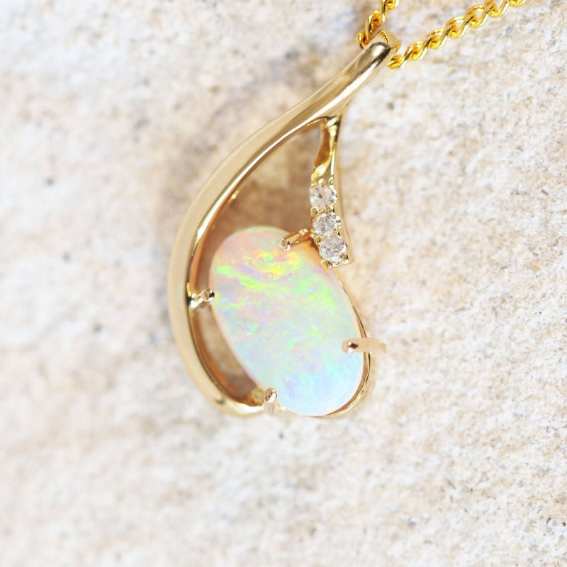 diamond and opal gold pendant set with three diamonds