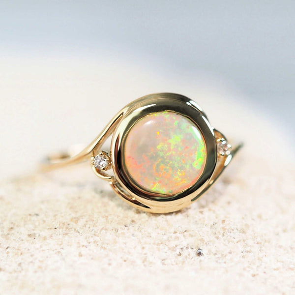 colourful crystal opal ring in gold with two diamonds