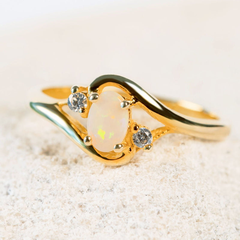white opal gold plated ring with two sparkling cubic zirconias