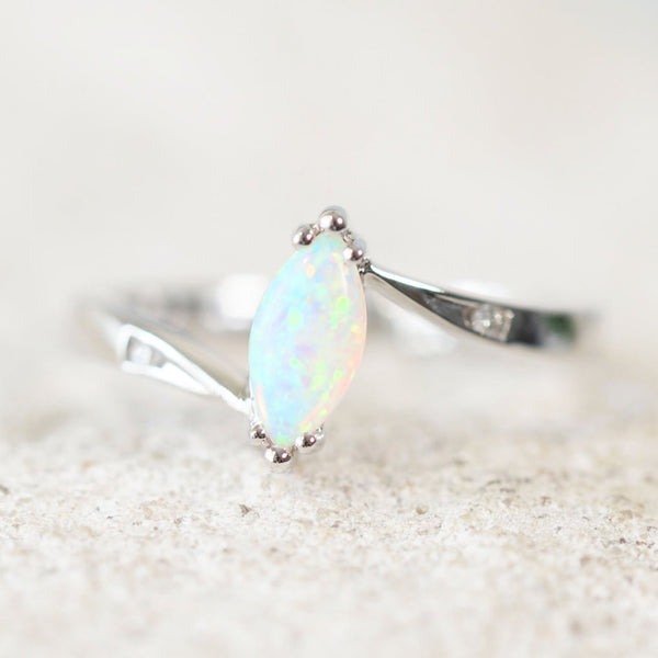 white gold white opal ring set with a marquise shape white opal carys