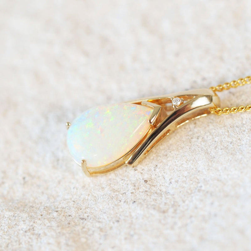 gold opal pendant with a white opal and diamond