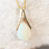 white opal gold pendant featuring a colourful floral patterned Australian opal