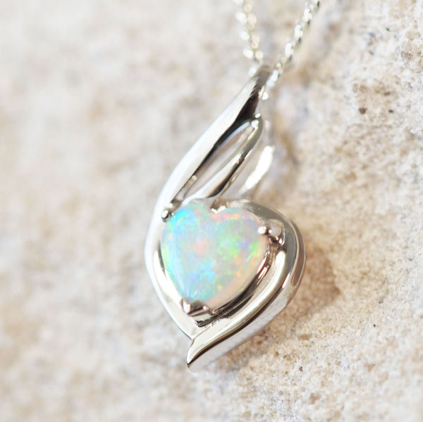crystal opal with multi-colouring and heart shaping set into a white gold pendant