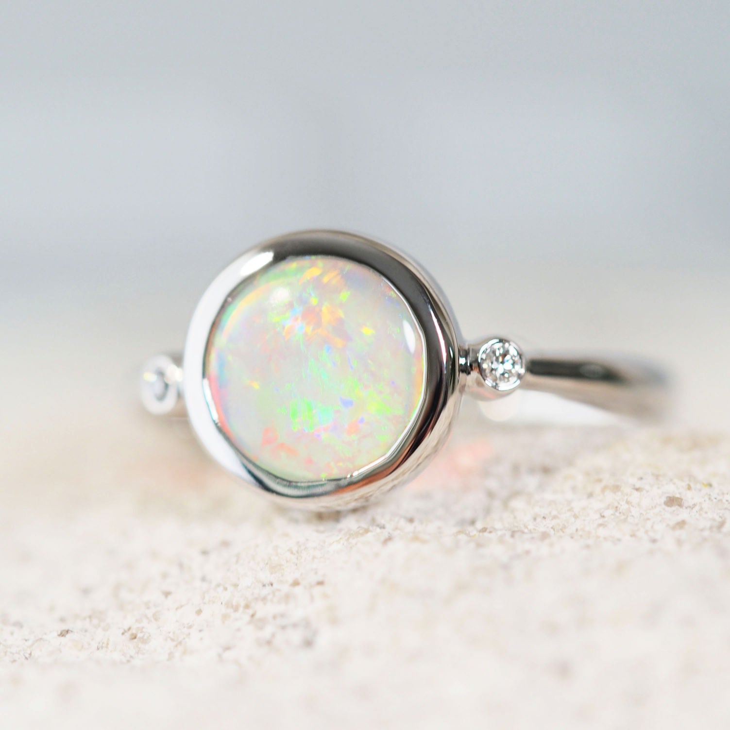 colourful crystal opal white gold ring with two diamonds 