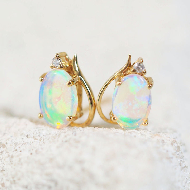 green and blue oval crystal opal earrings set in gold with diamonds