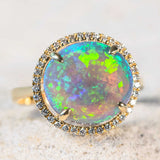 opal engagement ring with a round australian solid crystal opal set into an 18ct yellow gold ring surrounded by diamonds