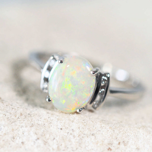 australian crystal opal ring set in white gold with six diamonds