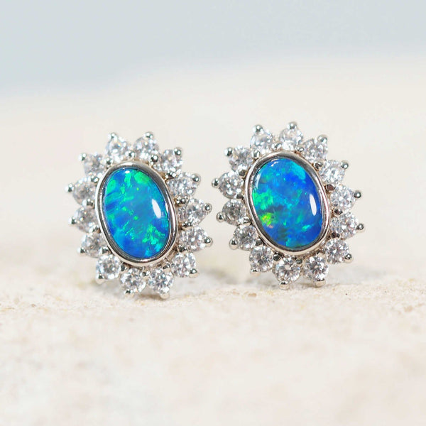 blue and green oval stud opal earrings set in silver with sparkling diamantes