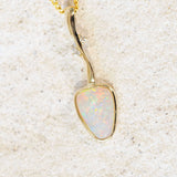 colourful triangular crystal opal set into a gold pendant 