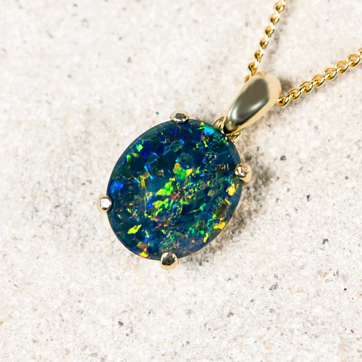 rich blue and colour triplet opal pendant set into gold plated silver