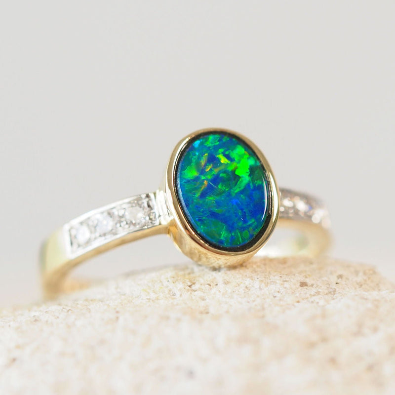 doublet opal gold ring featuring a green, blue and orange flash opal