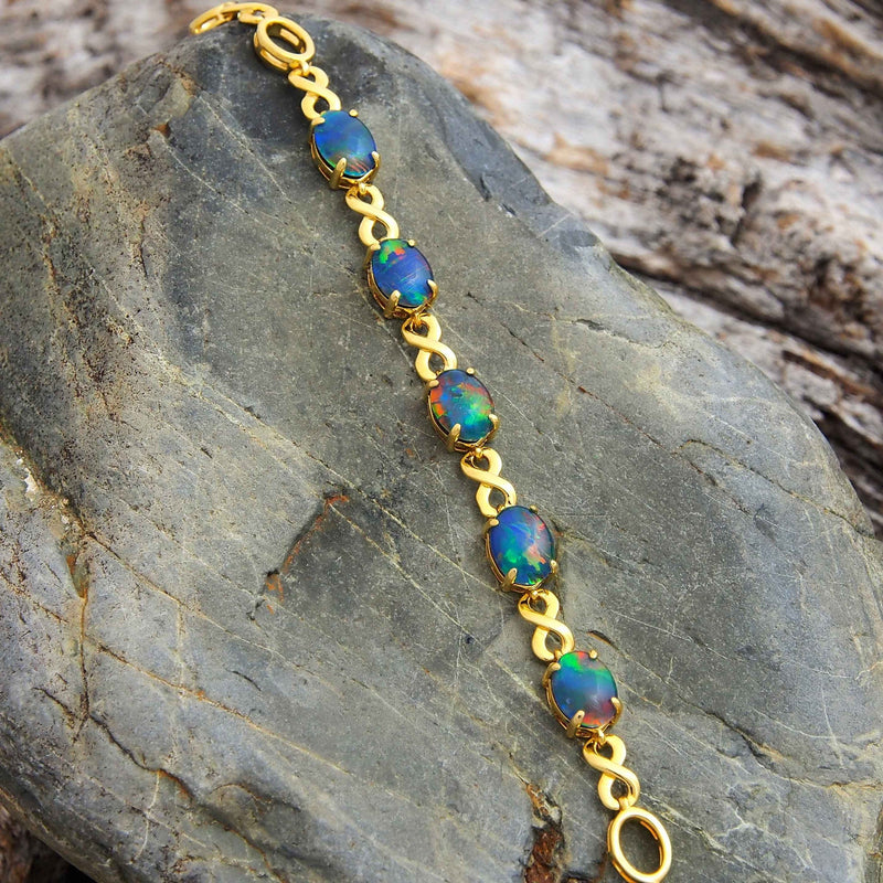 Figure-8 design gold plated sterling silver bracelet claw-set with five beautiful multi-colour oval triplet opals