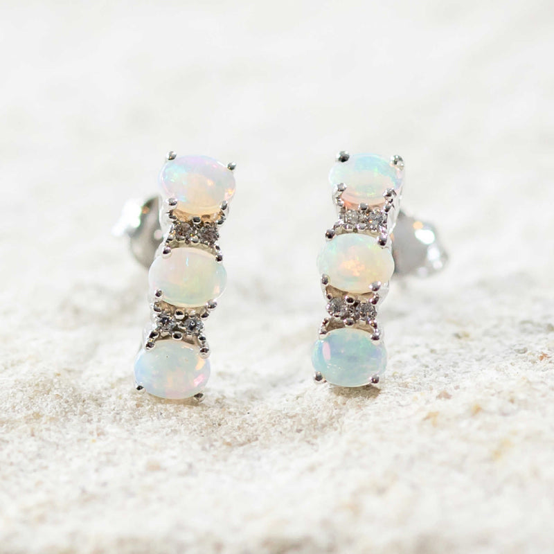 crystal opal stud earrings set with three australian opals and four crystals per eaarring