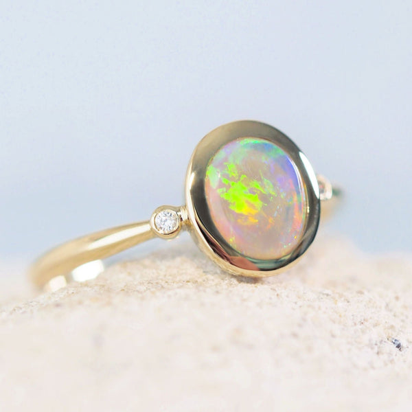 colourful round crystal opal gold ring with two diamonds