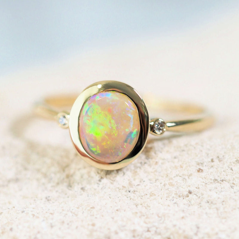 colourful australian crystal opal gold ring with two sparkling diamonds
