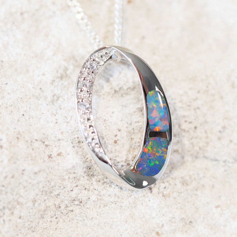 two colourful panels of doublet opal set into a sterling silver pendant with three sparkling crystals