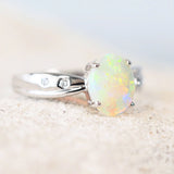 colourful oval crystal opal ring set in 14ct white gold with two diamonds