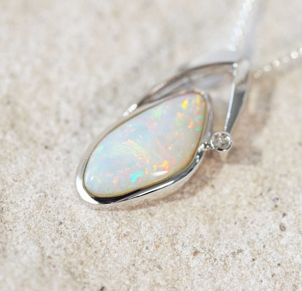 colourful white opal white gold pendant set with one sparkling diamons