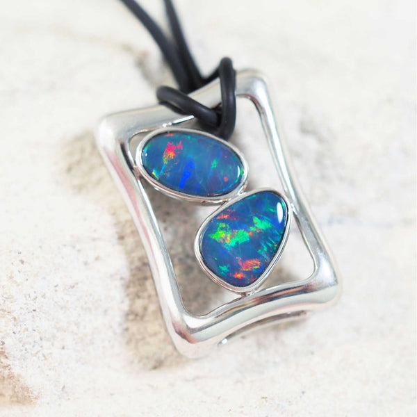 colourful australian opals set into fine quality silver pendant on a leather cord
