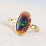 black opal with colourful flashes set into a gold opal ring