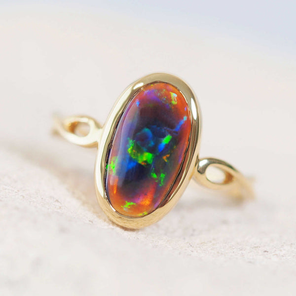 black opal with colourful flashes set into a gold opal ring