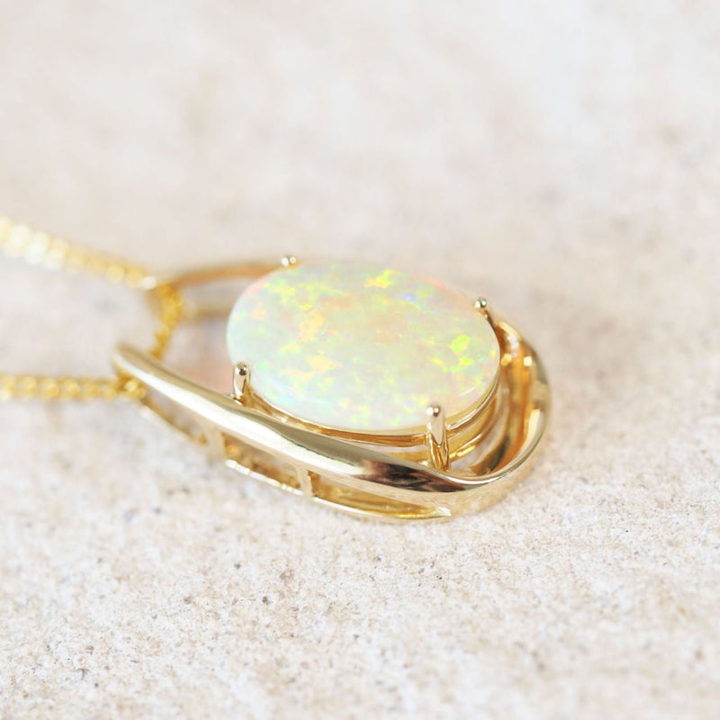 gold pendant set with a colourful crystal opal